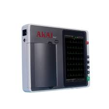 Portable medical monitor with a waveform display on the right and AKAI branding on the unit.