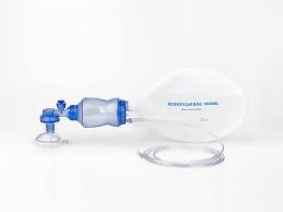 Medical inhalation spacer with mouthpiece and small blue valve attached to a clear bag for aerosolized medicine delivery.