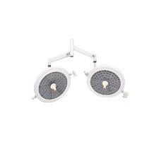 Dual circular surgical lights on an adjustable arm, used to illuminate the operating area.