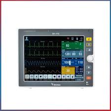 Medical patient monitor displaying ECG waveform and vital signs on a touchscreen panel (heart rate, SpO2, BP).