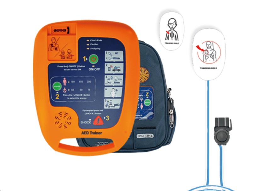 AED trainer device in bright orange with blue instructional panels and a blue carrying backpack, used for CPR/defibrillator training.