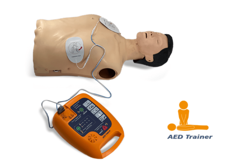 Screenshot 2026-08-23 161334 – مصر ميديكال CPR training manikin chest connected to an AED trainer, with an orange AED device nearby and an AED Trainer logo on the right.