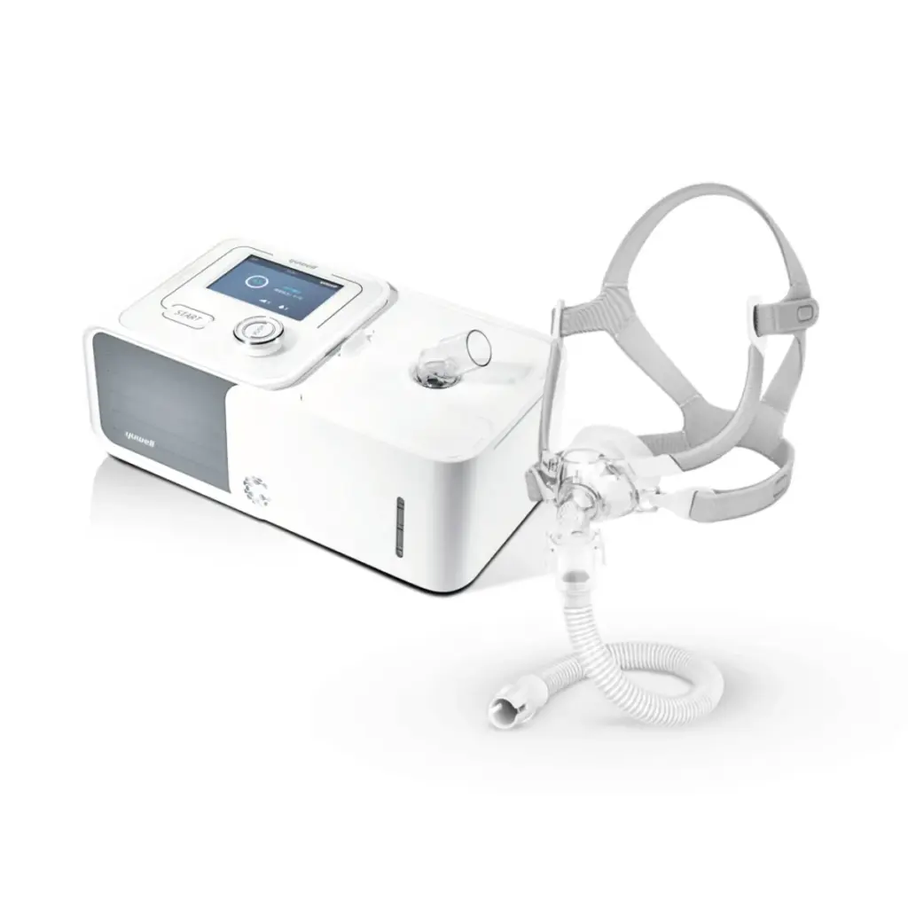 White CPAP sleep apnea machine with mask, tubing, and headgear for nighttime use.